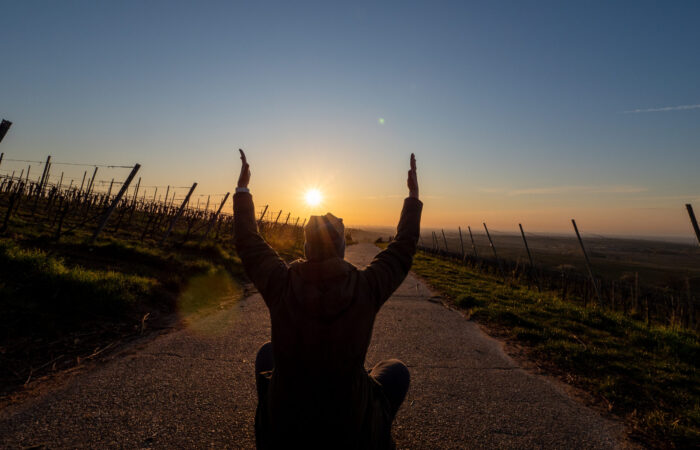 Arme hoch im Sonnenaufgang